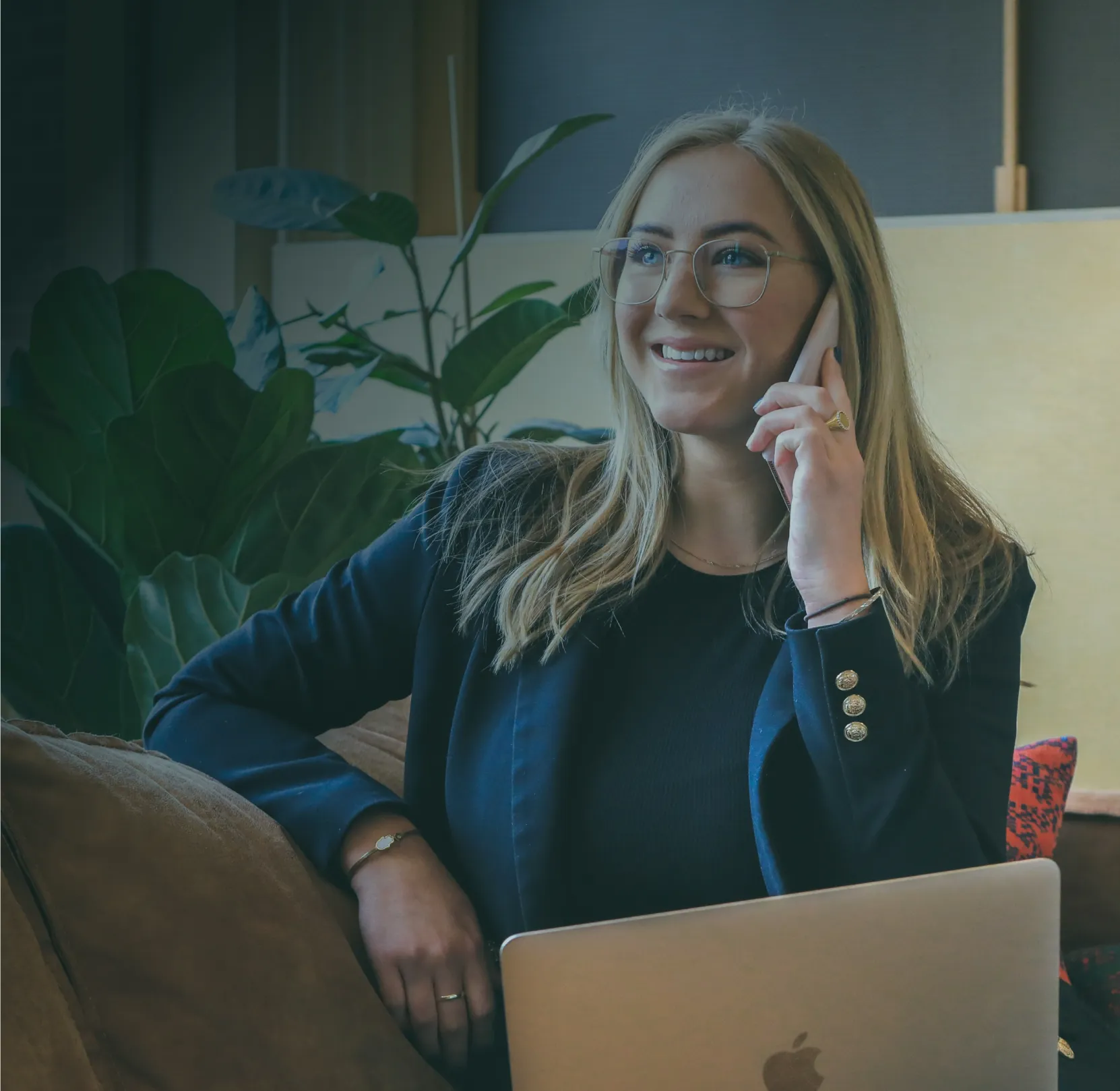 A consultant taking a call at her desk